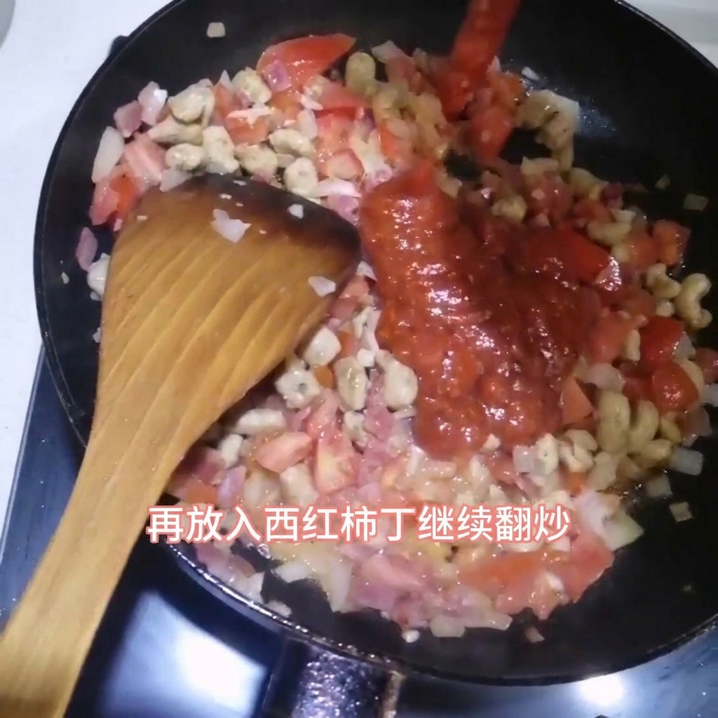 Pasta sauce being poured into a frying pan containing diced bacon, beef cubes, and onions, with a wooden spatula ready to stir.