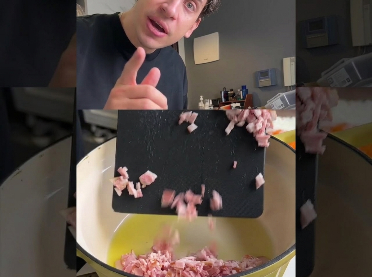Chopped pancetta being added to a hot pot containing oil and diced vegetables.