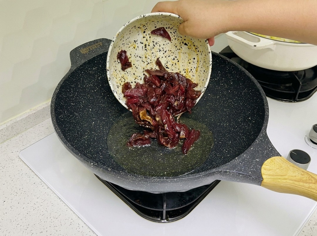 Marinated beef strips sizzling in a hot wok.