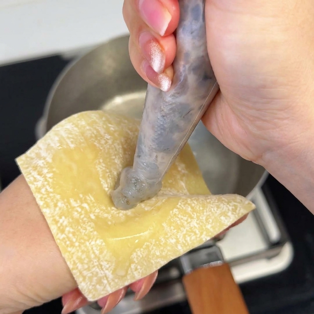 A portion of cooked, wavy ramen noodles being added to the miso soup broth.