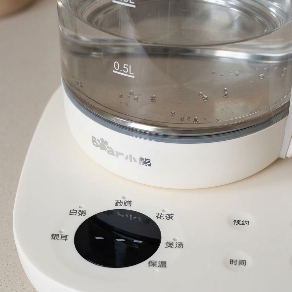 A whole raw egg being lowered into an electric kettle containing hot water.