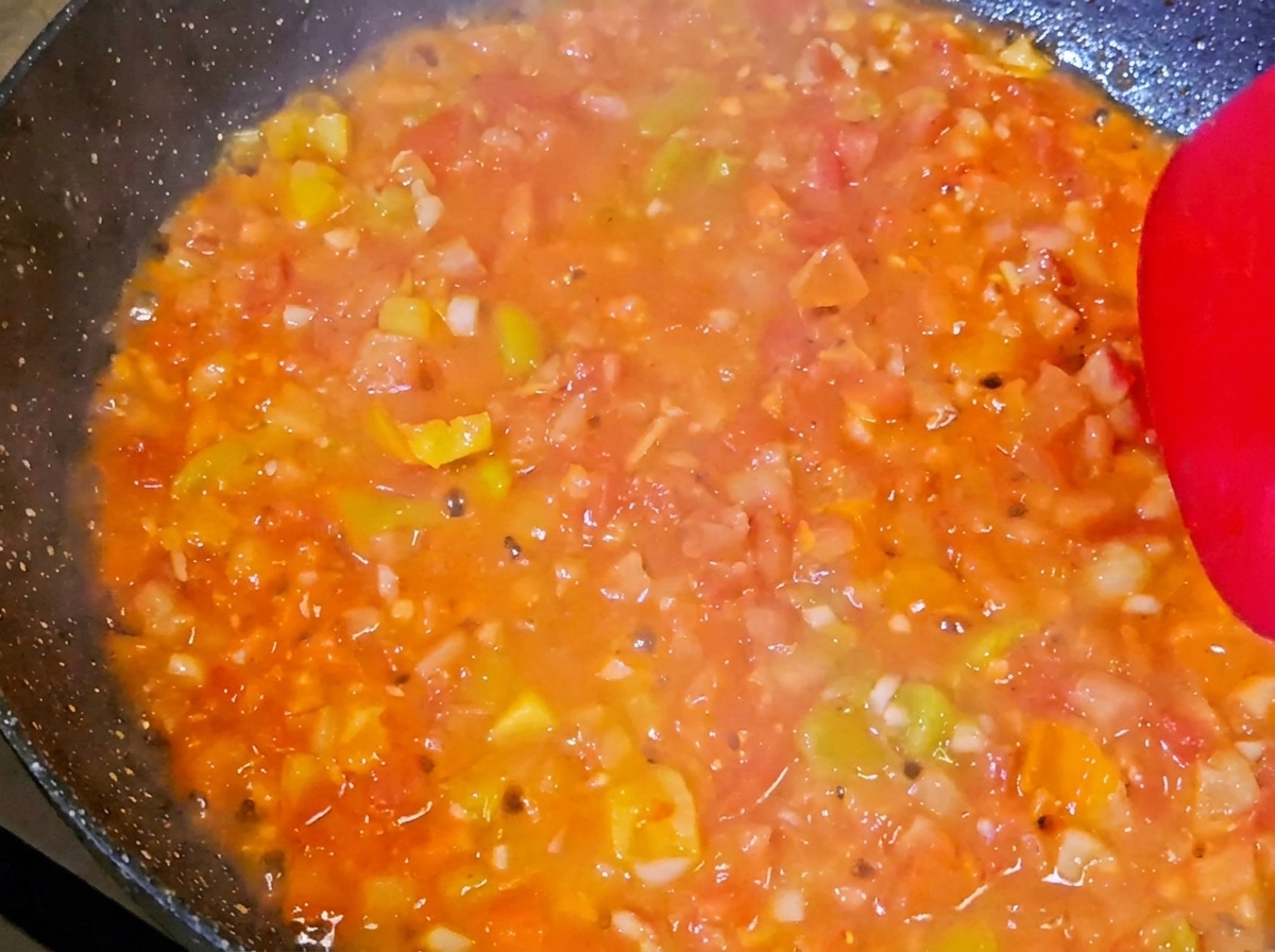 Beef, crab sticks, and broccoli mixed with tomato sauce.