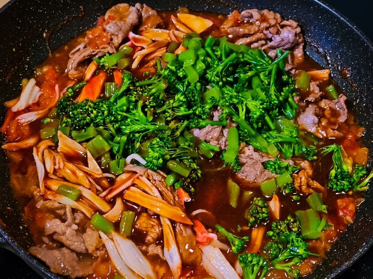 Liquid sauce being poured over the mixture in the pan.