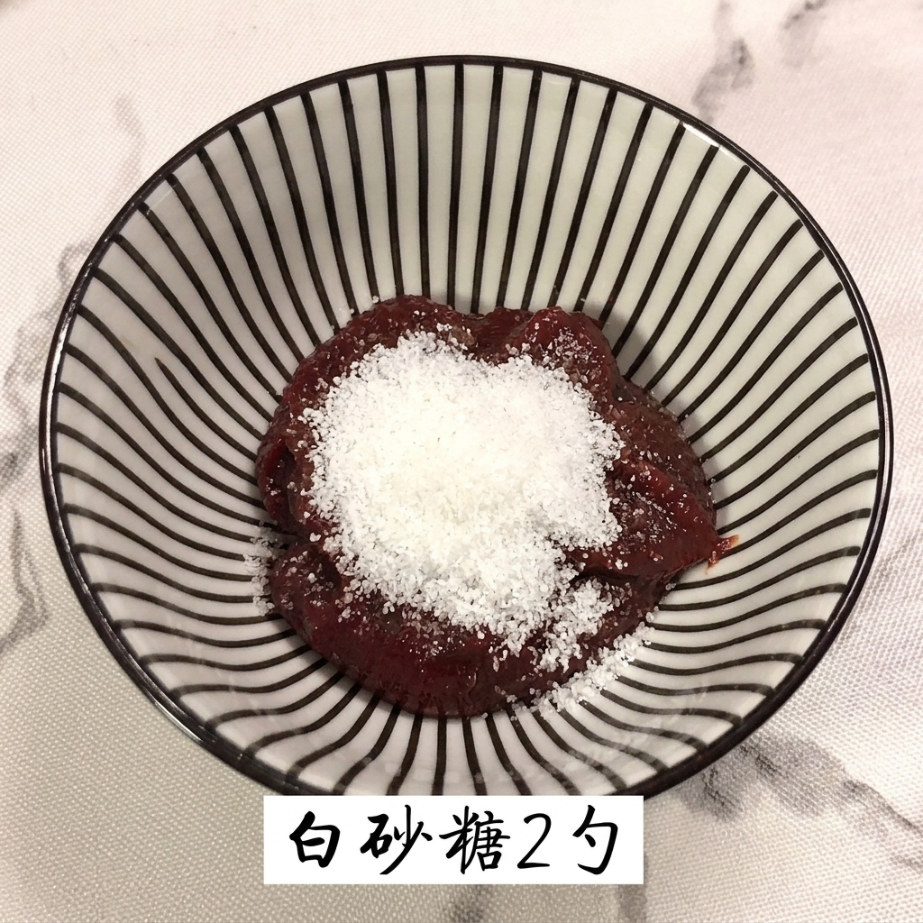 White granulated sugar being added on top of the dark red chili paste in the mixing bowl.