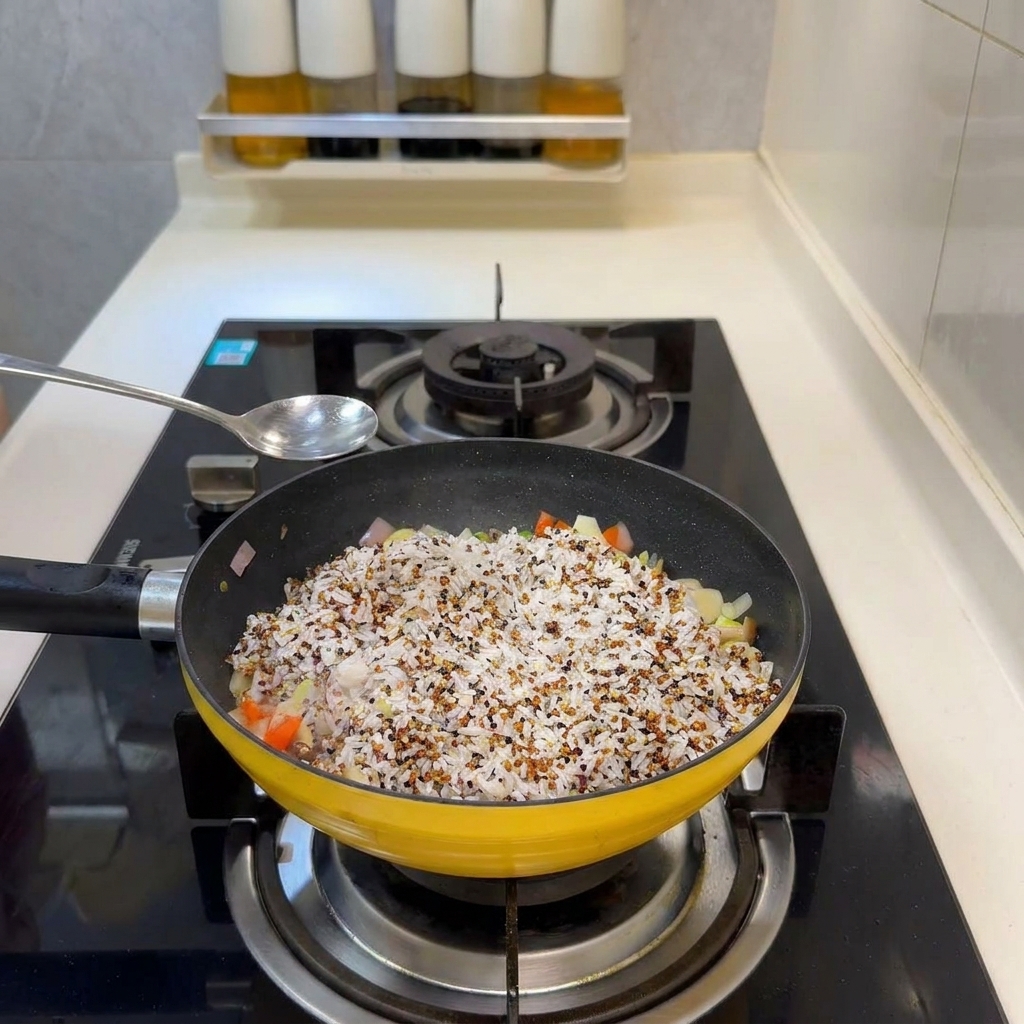 A silver spoon held over a yellow pan filled with rice and colorful vegetables, ready to add seasoning.