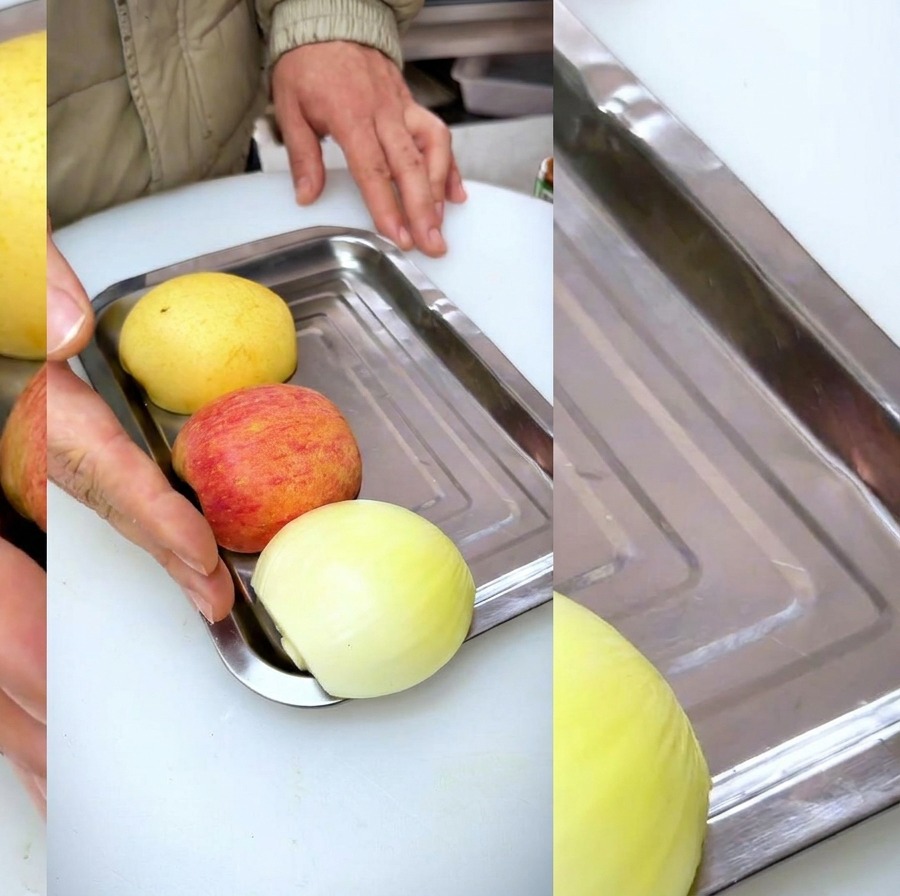 Sliced onion, apple, and pear arranged on a stainless steel tray in preparation for making a marinade.