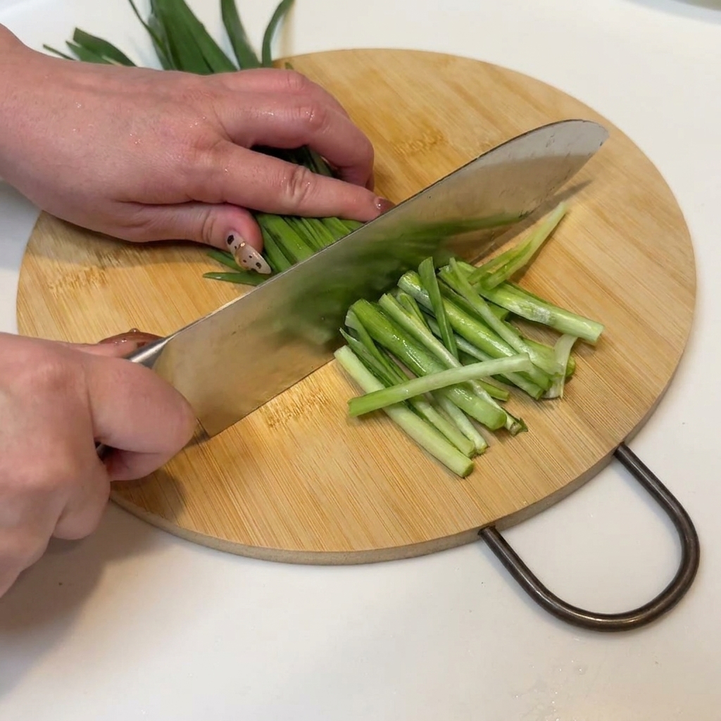Green onions and chives neatly sliced and ready for the pan.