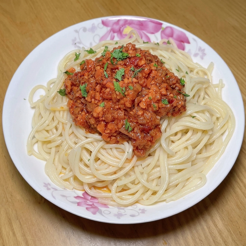 Fresh diced tomatoes being added to a pan with the meat, vegetables, and tomato paste.