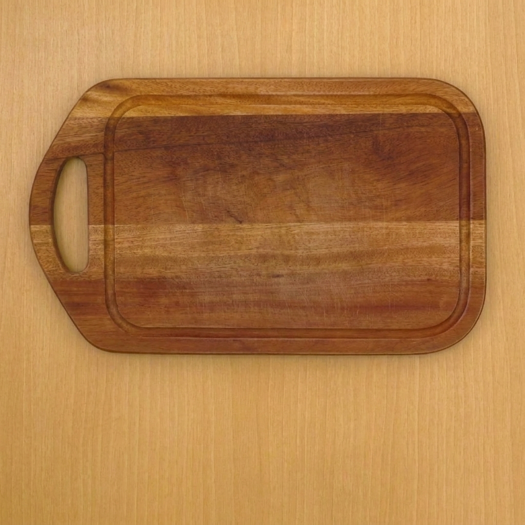 Fresh ginger root being sliced into thin rounds on a wooden surface.