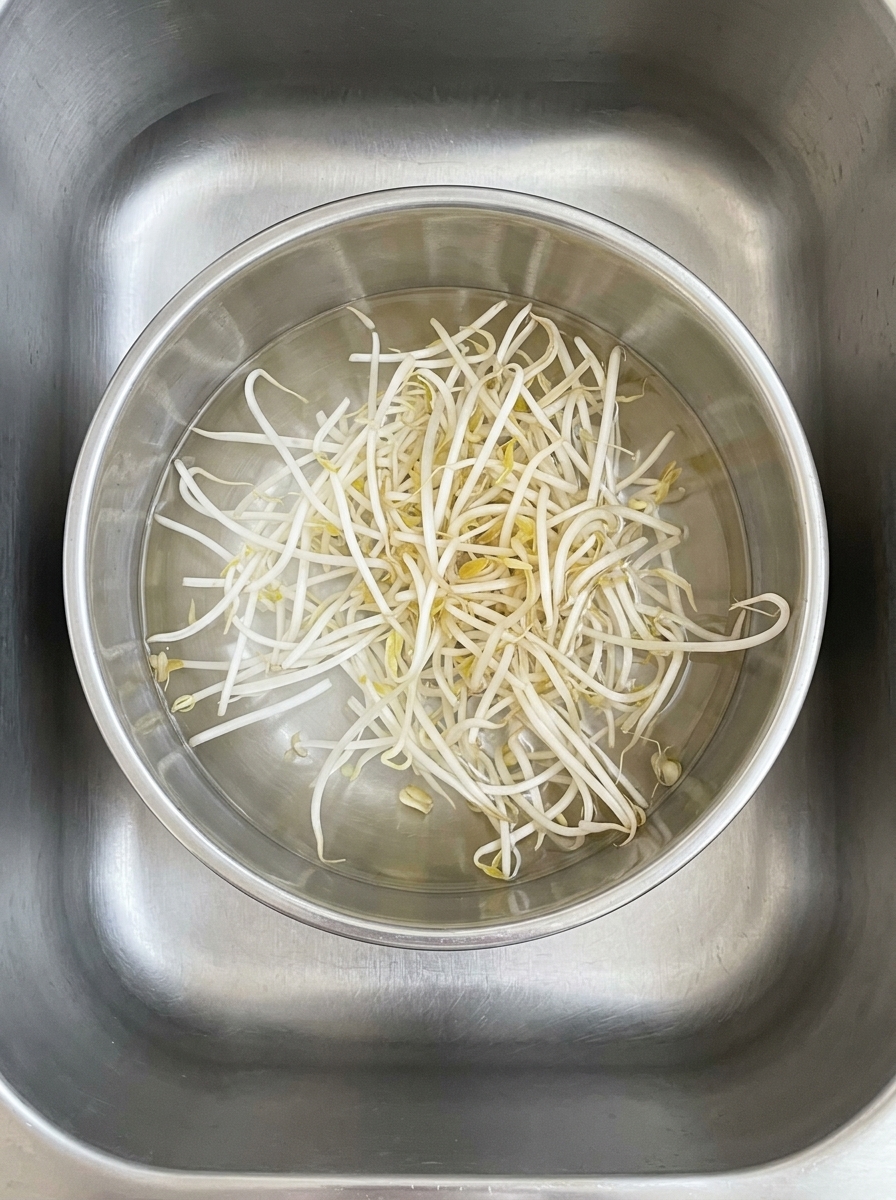 Cornstarch being added to the bowl of seasoned raw minced meat.