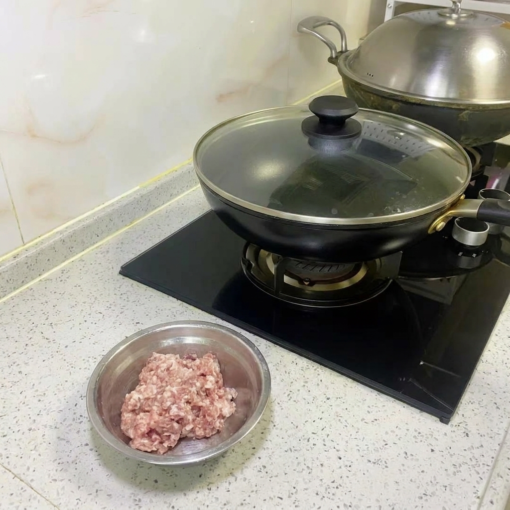 A layer of shredded cabbage being arranged in a non-stick pan.