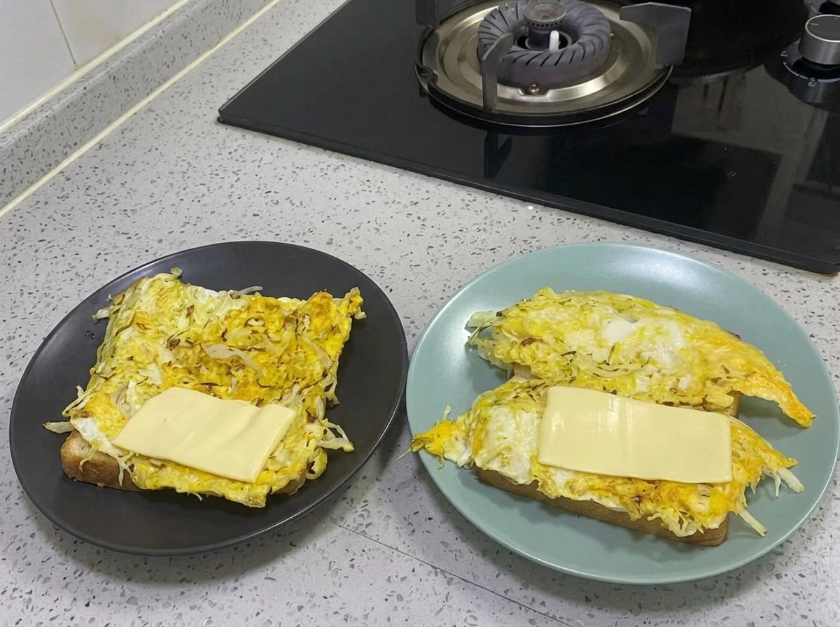 Honey mustard sauce being drizzled over the cheese layer.