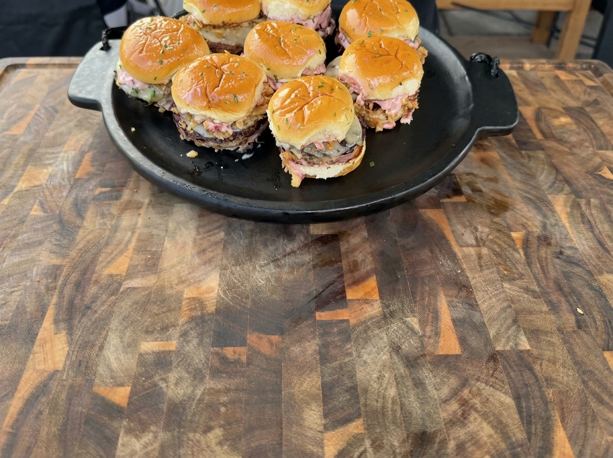 Turkey patties searing on a hot griddle, showing golden-brown edges.