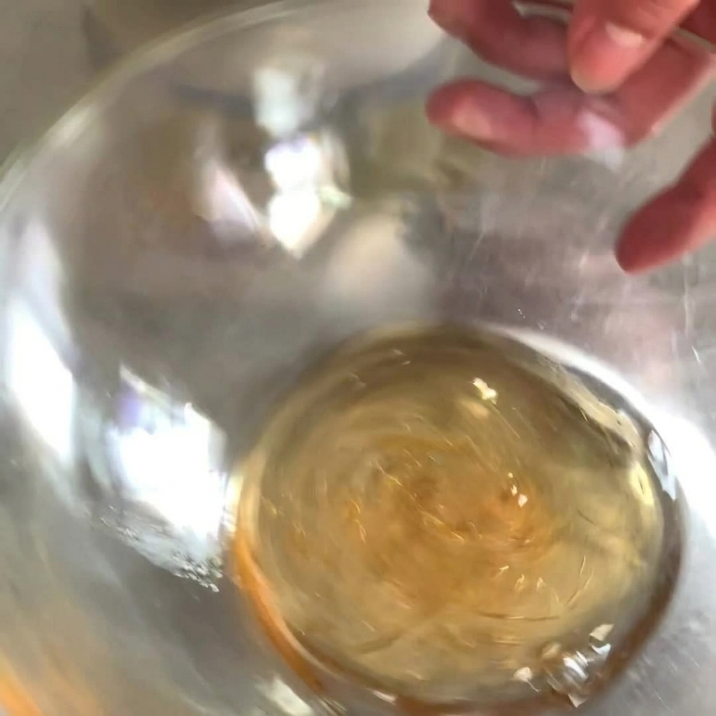 Green horseradish sauce being added to the honey and mustard base.