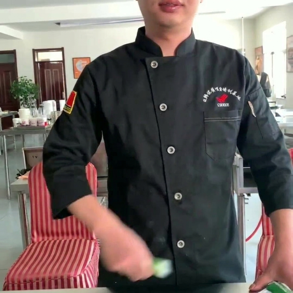A whisk blending the sauce ingredients together in a glass bowl.