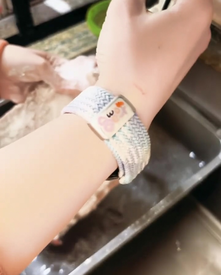 Flour-coated pork ribs being rinsed under a kitchen faucet.