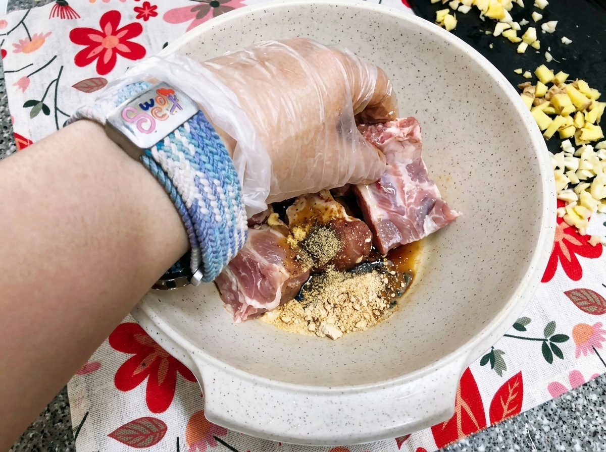 Freshly blended apple puree being poured over the seasoned pork ribs.