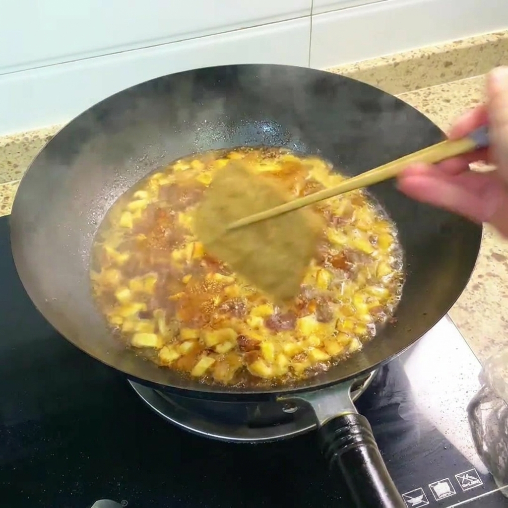 Fried tofu pieces simmering in a rich, dark, and bubbling broth inside a wok.