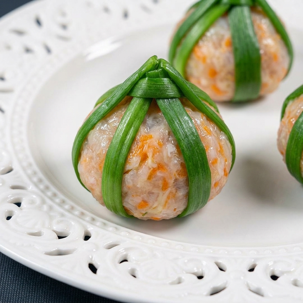 Close-up of a perfectly formed shrimp paste ball encased in arranged blanched okra slices.