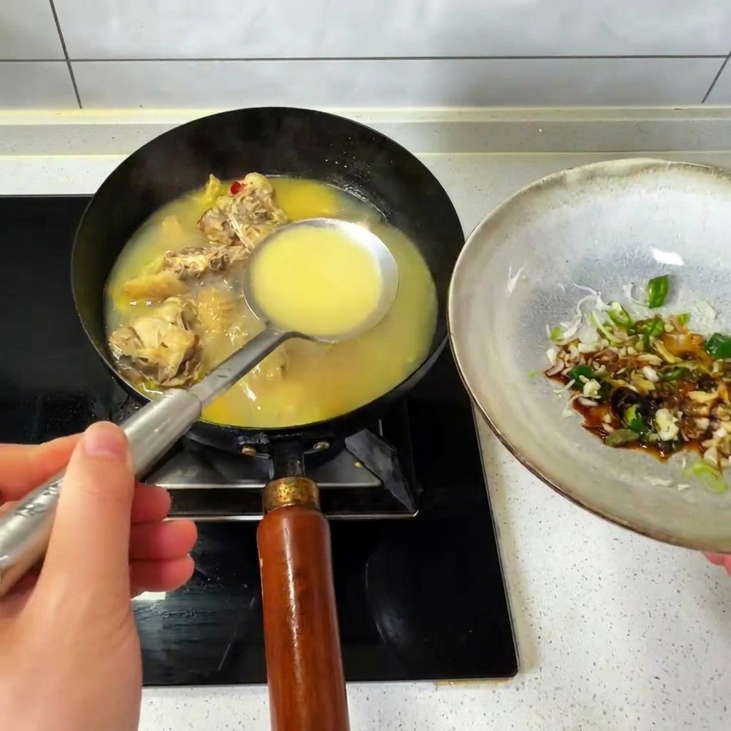 Pouring a ladle of hot chicken broth from a wok into a bowl of seasonings.