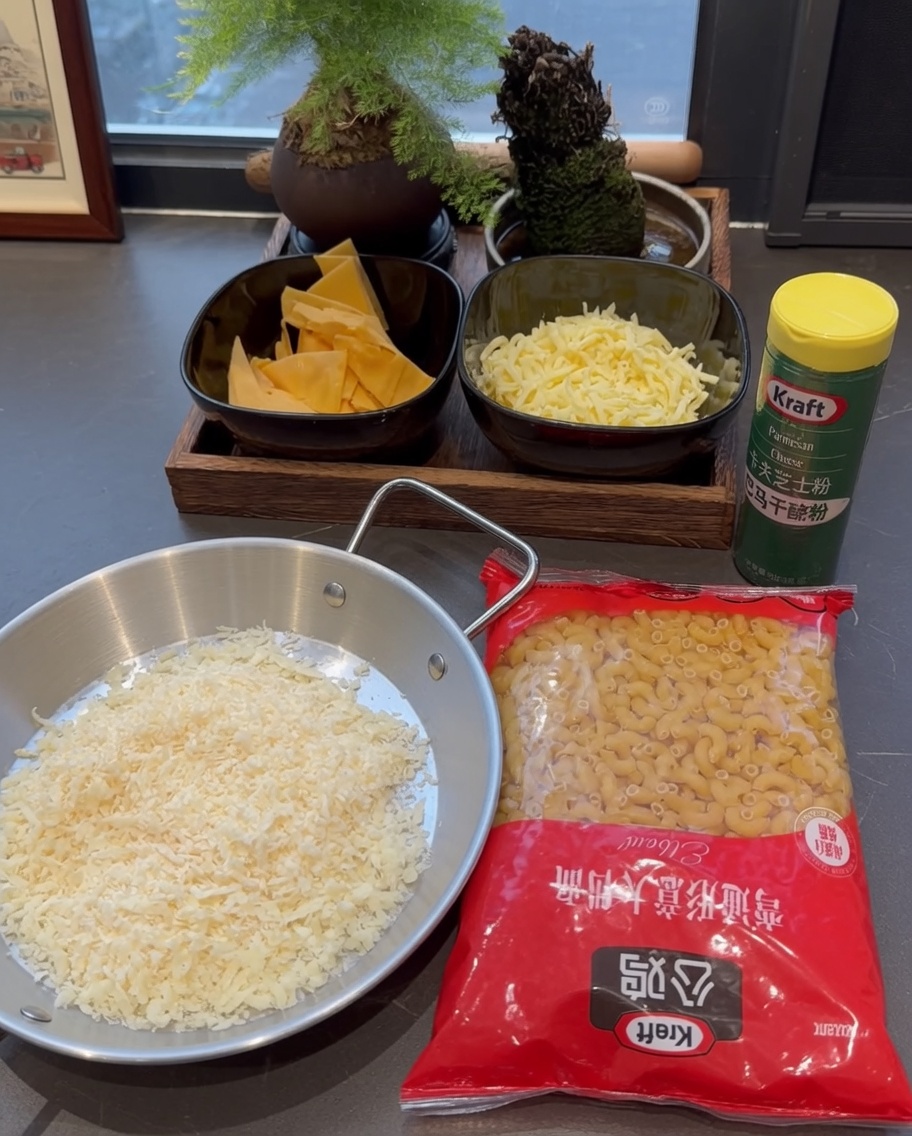 Dry macaroni pasta being poured into a pot of boiling water.
