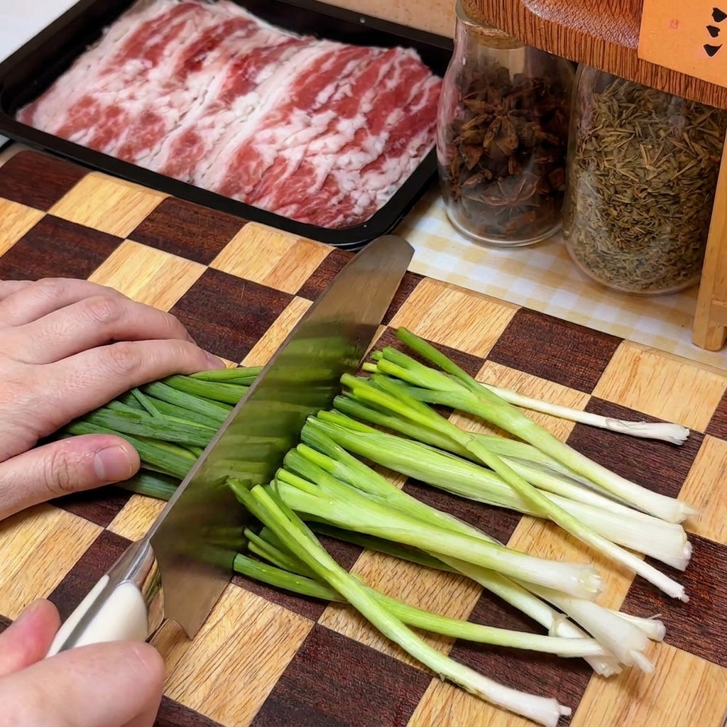Finely chopped green onions piled on a checkered wooden cutting board next to a container of beef.