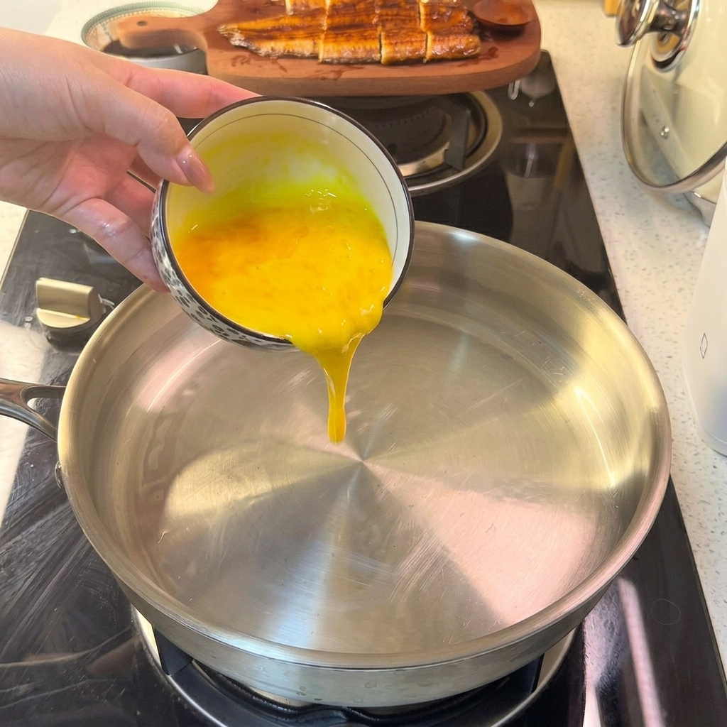 Liquid egg mixture hitting a hot pan, starting to set into a thin layer.