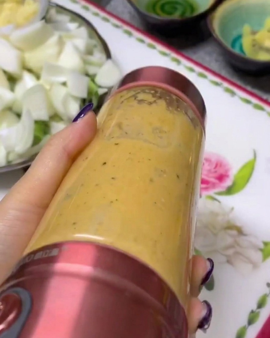 A smooth, blended vegetable and fruit purée inside a portable blender cup.