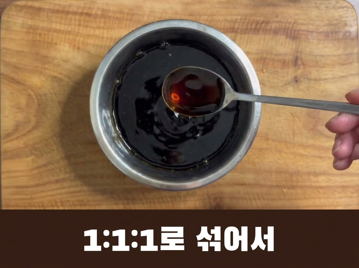A dark, savory seasoning mixture being poured from a spoon into the pot.