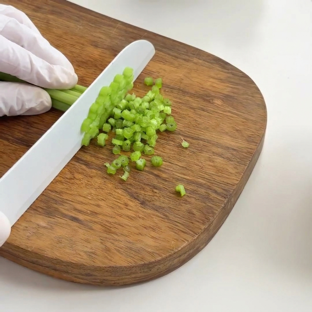 Finely chopped green celery pieces ready for the soup base.
