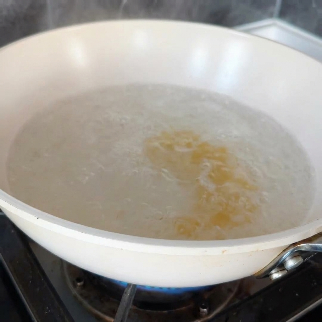 Fusilli pasta boiling in a large pot of water on the stove.