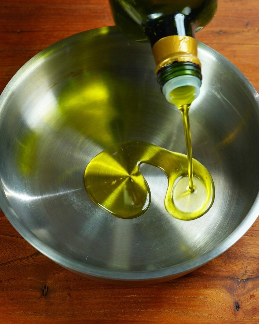Garlic and onion frying in oil in a pan.