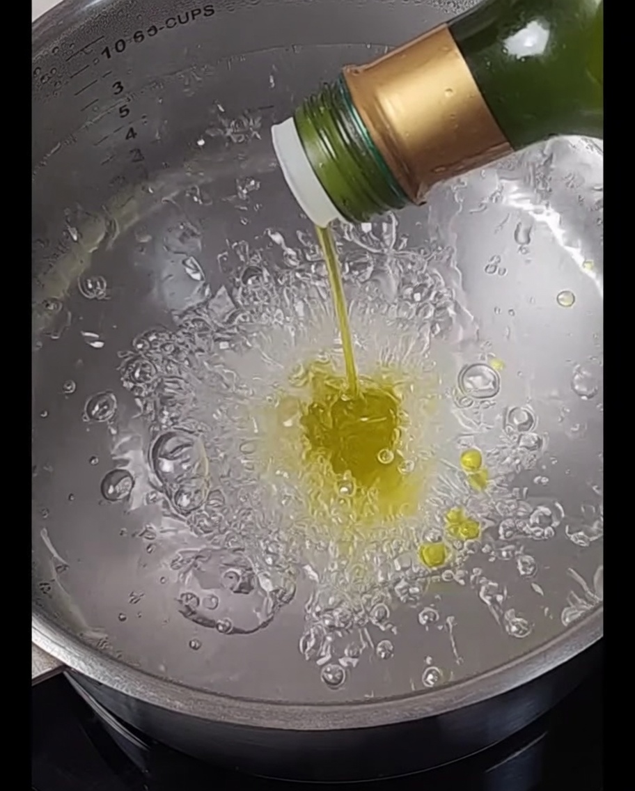 Spaghetti pasta submerged in a pot of boiling water.