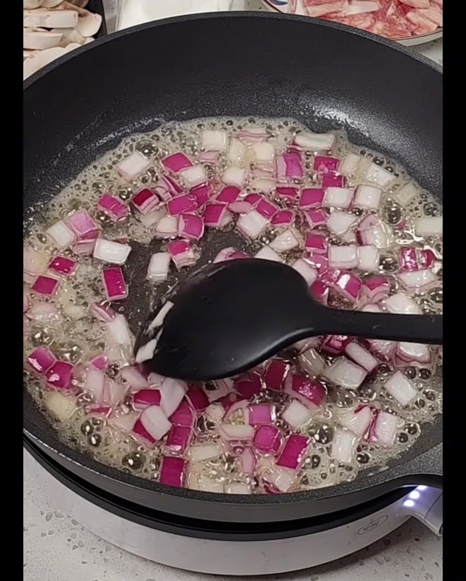 Diced red onions cooking in melted butter.