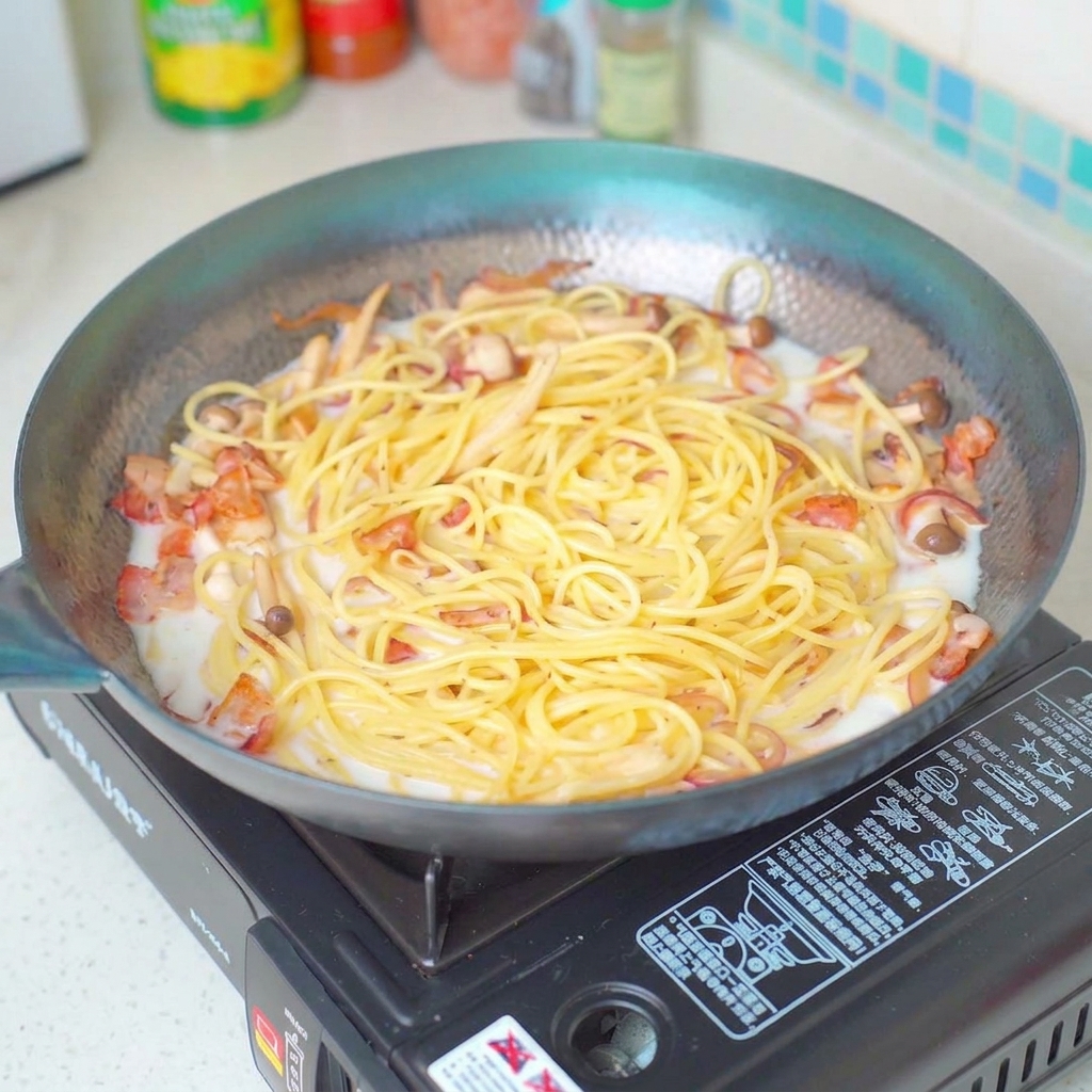 Seasoning the pasta dish with salt while it simmers in the pan.