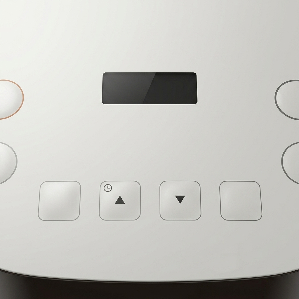 A hand pressing the start button on the control panel of a white rice cooker.