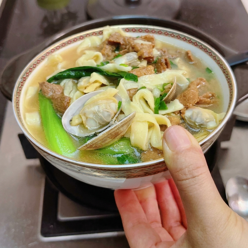 Marinated meat slices being placed into a hot, empty clay pot.