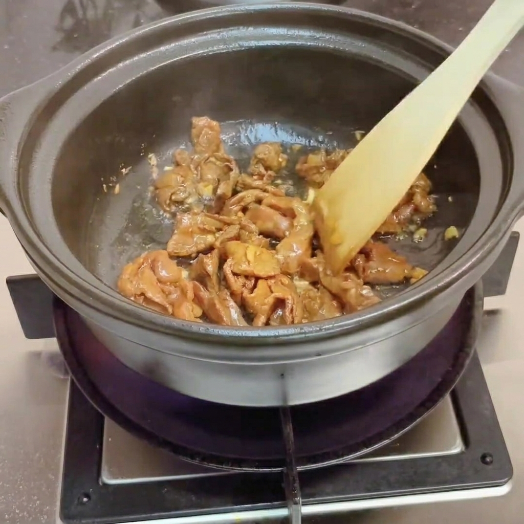 Clams added to the pot with hot water being poured over them.