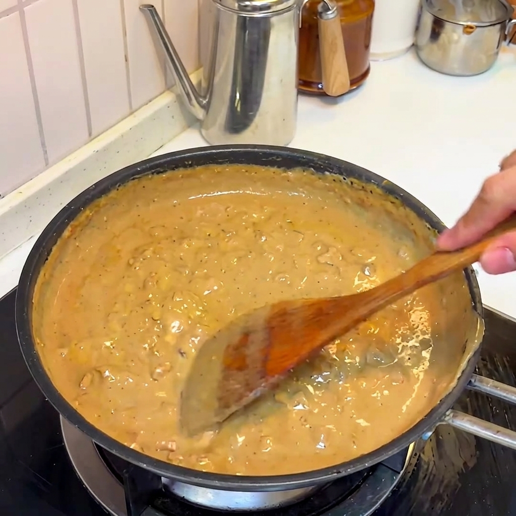 The rich miso and pork sauce simmering and thickening in the pan.