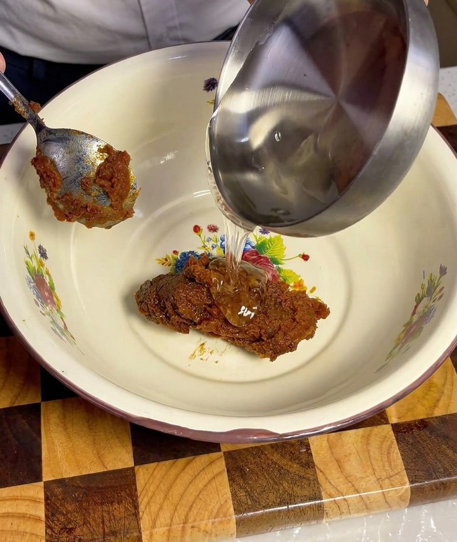 Liquid ingredients including soy sauce, cooking wine, and malt syrup being poured into the bowl with Doenjang.