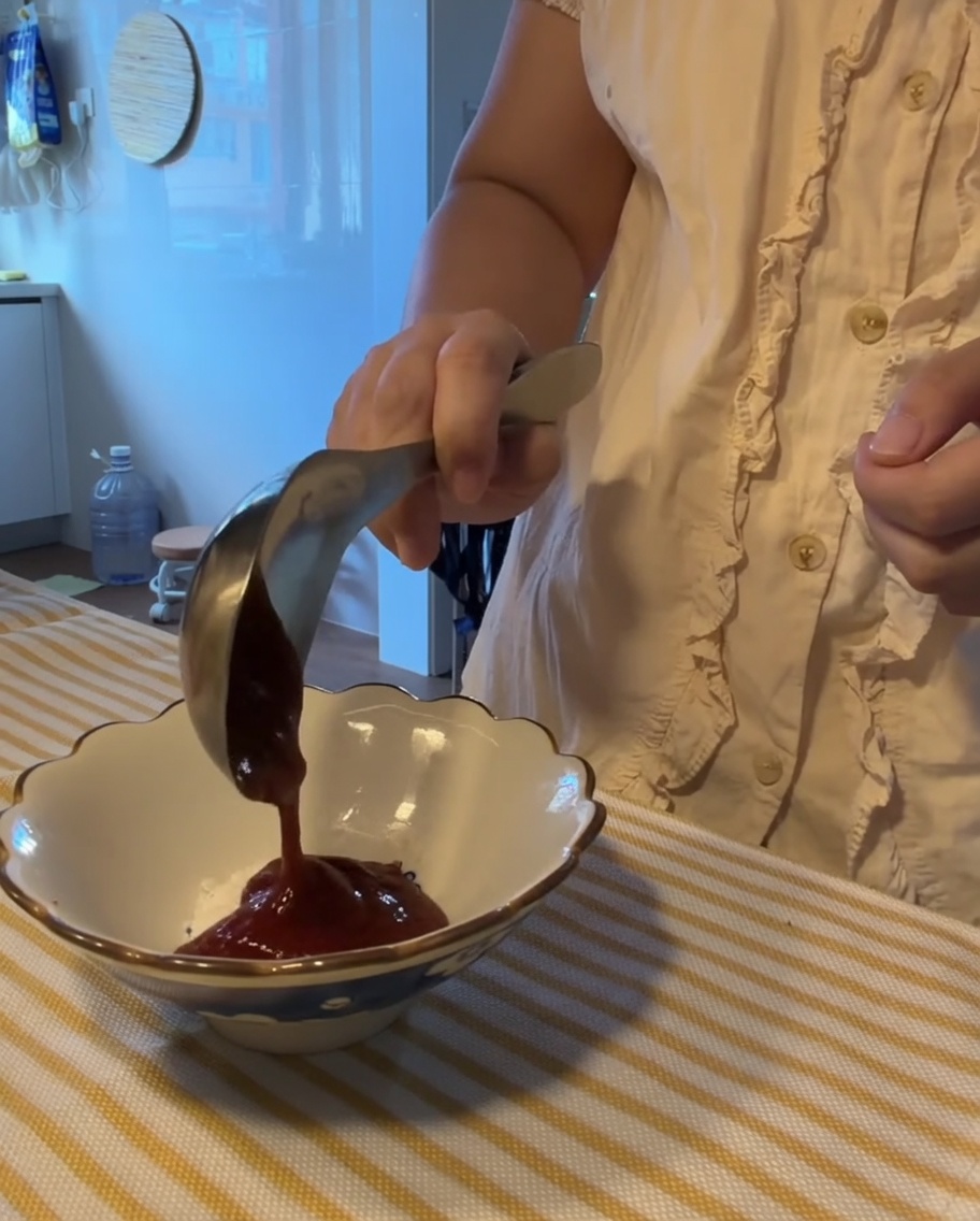 A variety of sauces and seasonings being mixed together in a small white bowl.