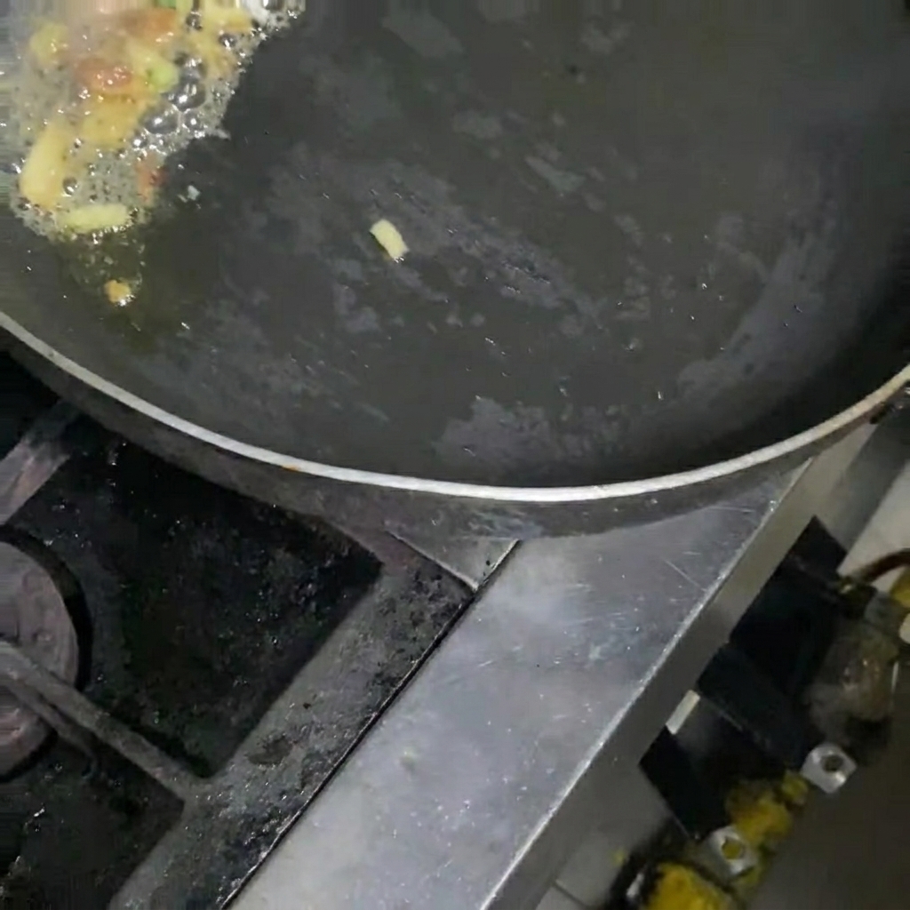 Kimchi being stir-fried in a pan with pork and onions.