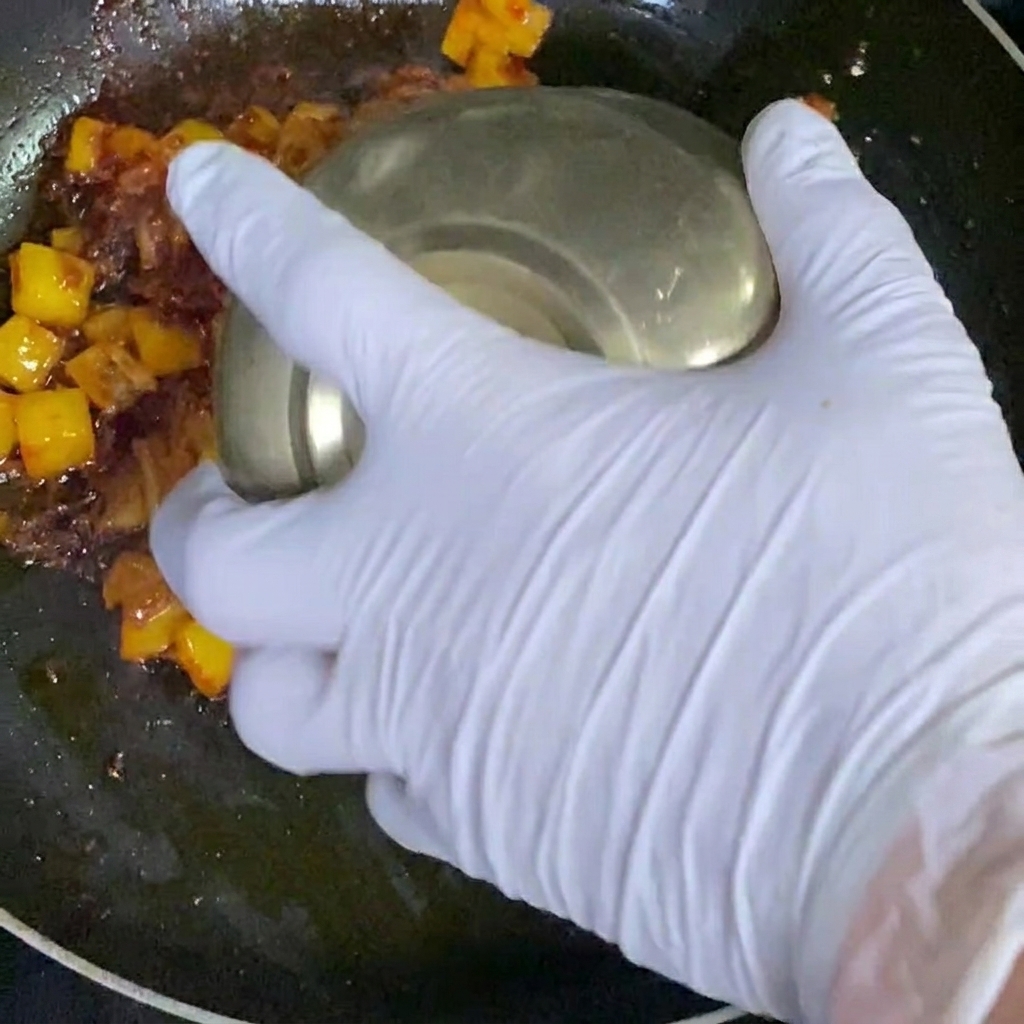 White rice being added to the pan of ingredients.