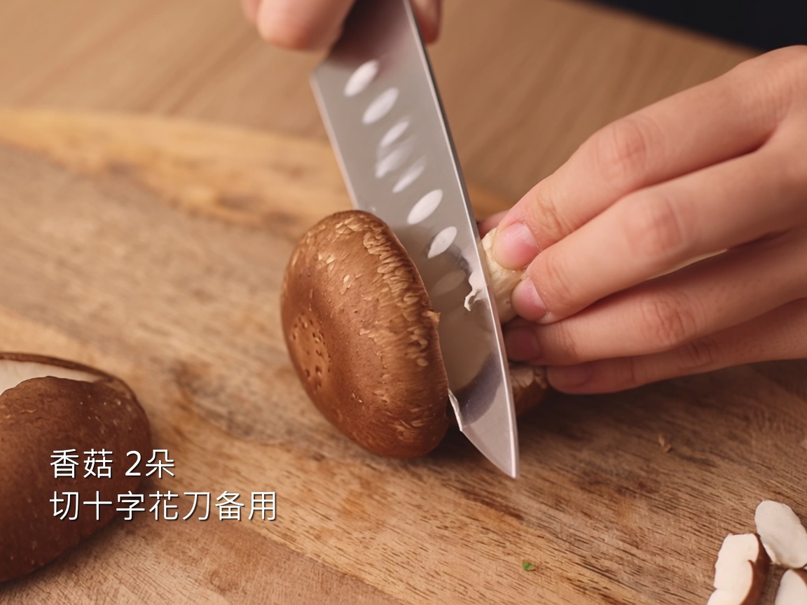 A knife carving a cross shape into the top of a fresh shiitake mushroom on a wooden board.