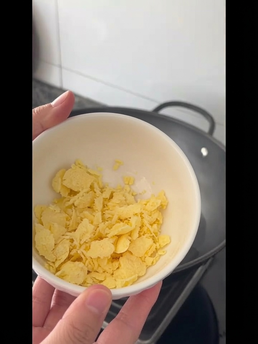 Butter cubes melting into the hot oil in the wok.