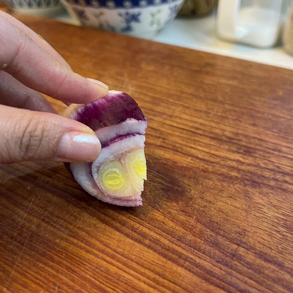 Finely diced red onion pieces ready to be used as an aromatic base.