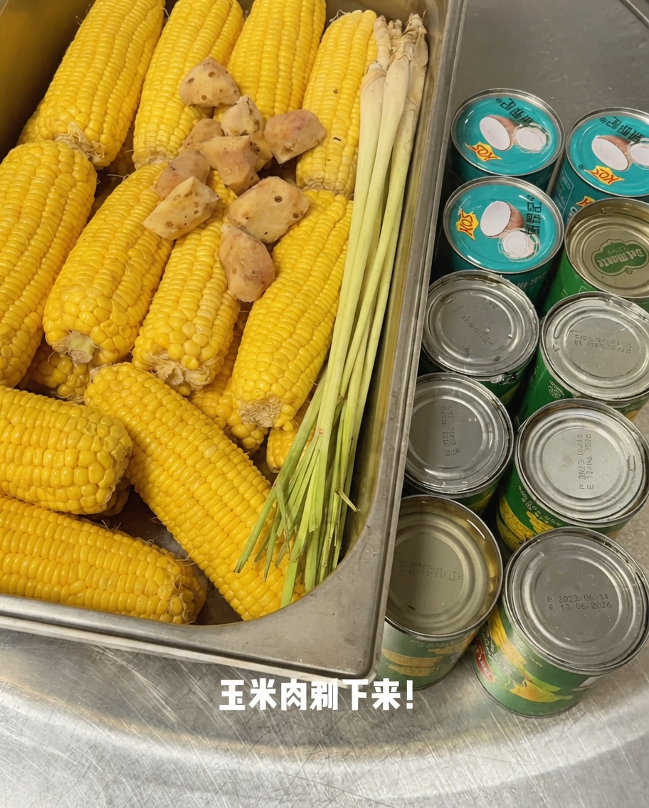 Fresh corn kernels being sliced off the cob on a cutting board.