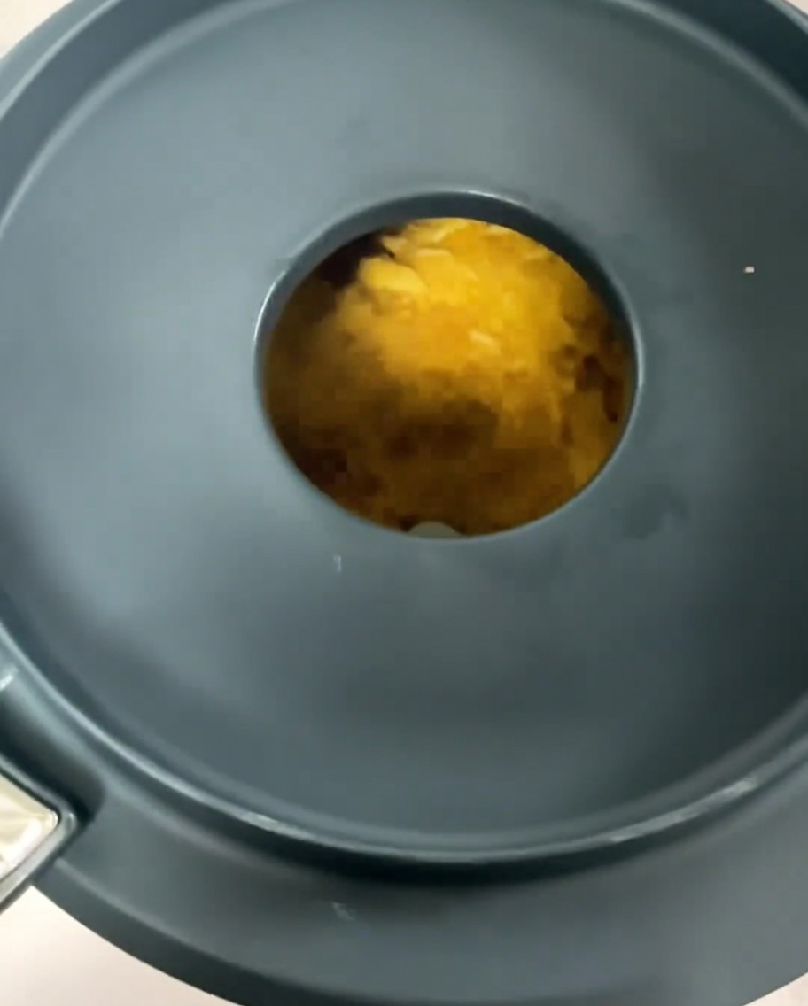 Corn soup being blended into a smooth, thick yellow puree in a high-speed blender.