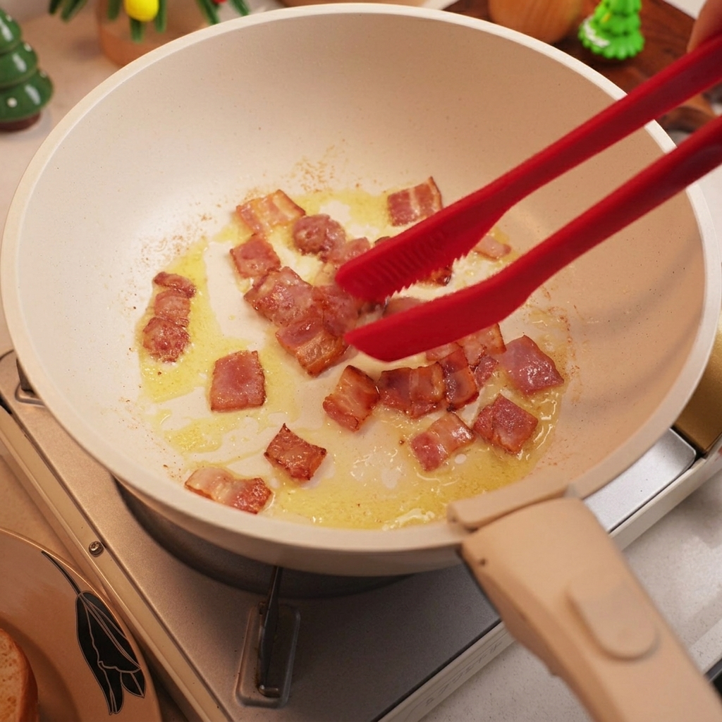 Diced bacon frying in a pan until crispy and golden.