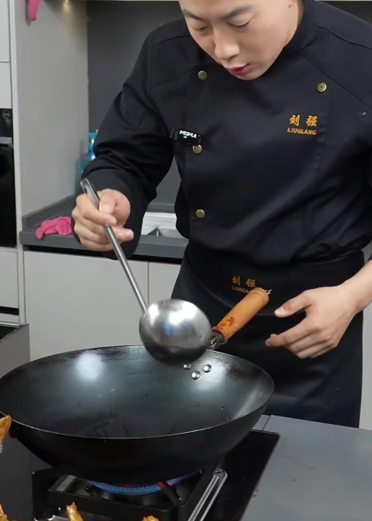 A hot wok with melting lard and shimmering cooking oil, ready for ingredients.